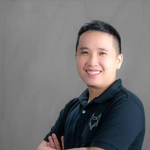 Anh Phạm Hoàng Quân, người sáng lập Tài Chính Khởi Nghiệp, mặc áo thun đen, khoanh tay, cười